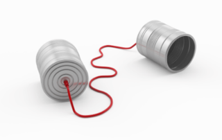 Two tin cans with a red rope connected.