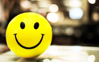 Yellow smiley face on a glass table.