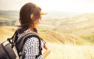 Young woman looking far into the valley.