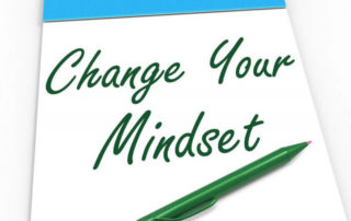 Paper with wording that says change your mindset with a green pen