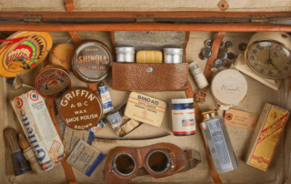 Old suitcase with old travelling accessories.