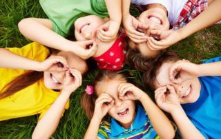 Happy children lying in a circle.