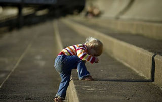 A little boy climbing stairs.