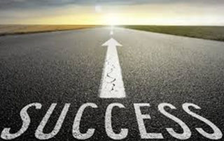 Open road with arrow and text saying success on the road.