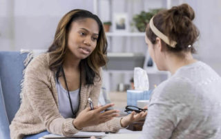 Two woman talking with each other.